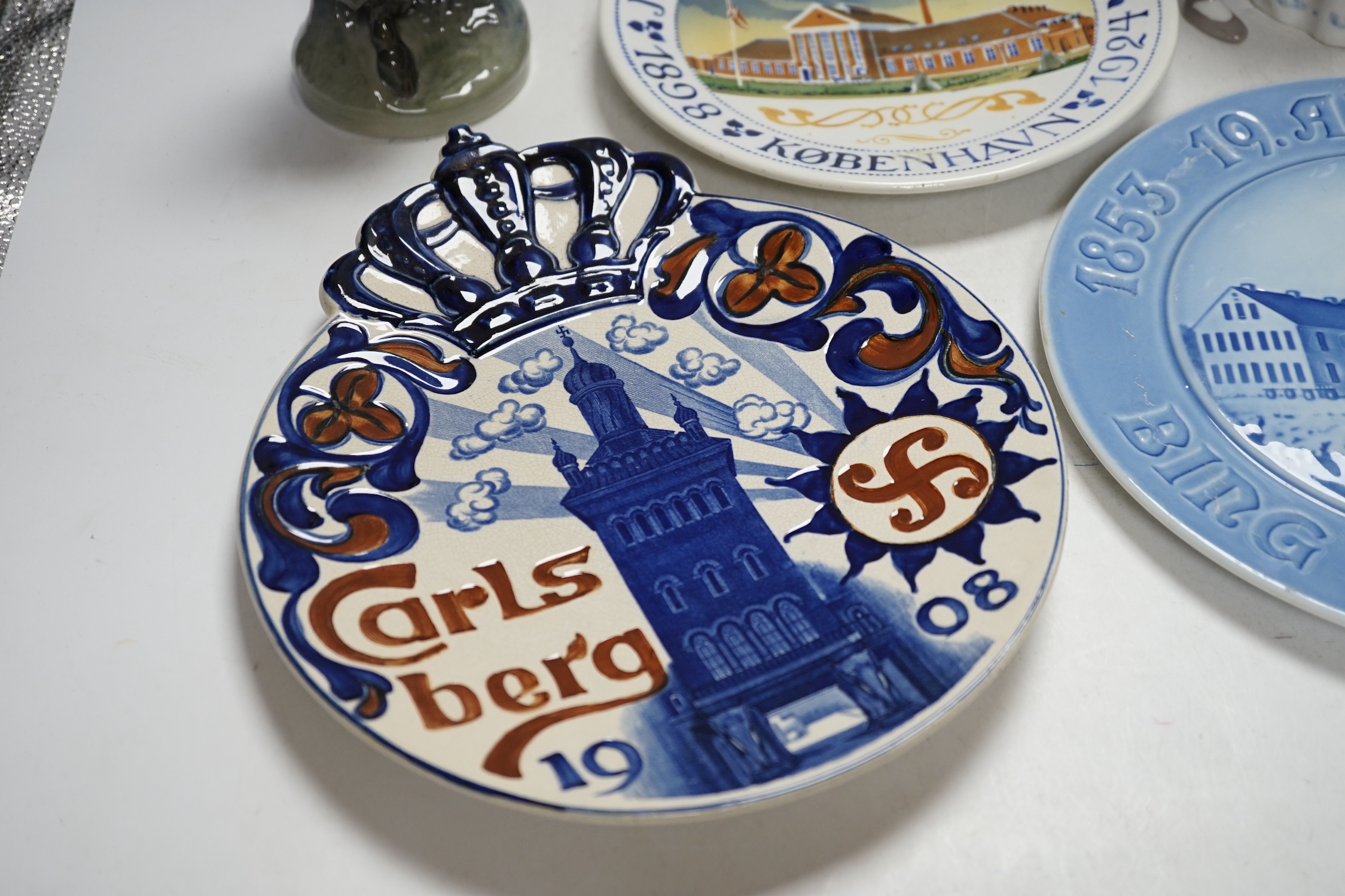 Three Royal Copenhagen and Bing and Grondahl commemorative plates and two figure groups, largest Carlsberg commemorative advertising plate 25.5cm high